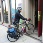 Scott with commuter bike entering the office