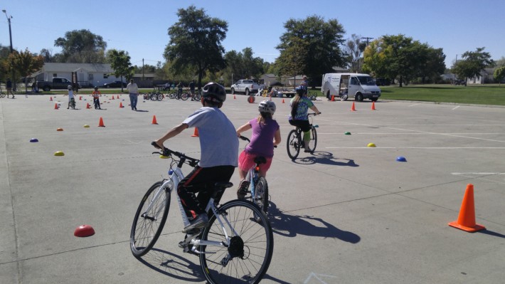 Kids ride through the community "bike rodeo" at Prairie Park.