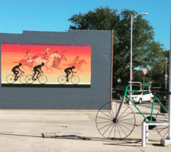 Outside Sterling Bicycle Works, a bike sculpture and a mural painted for Pedal the Plains 2014 and 2015.