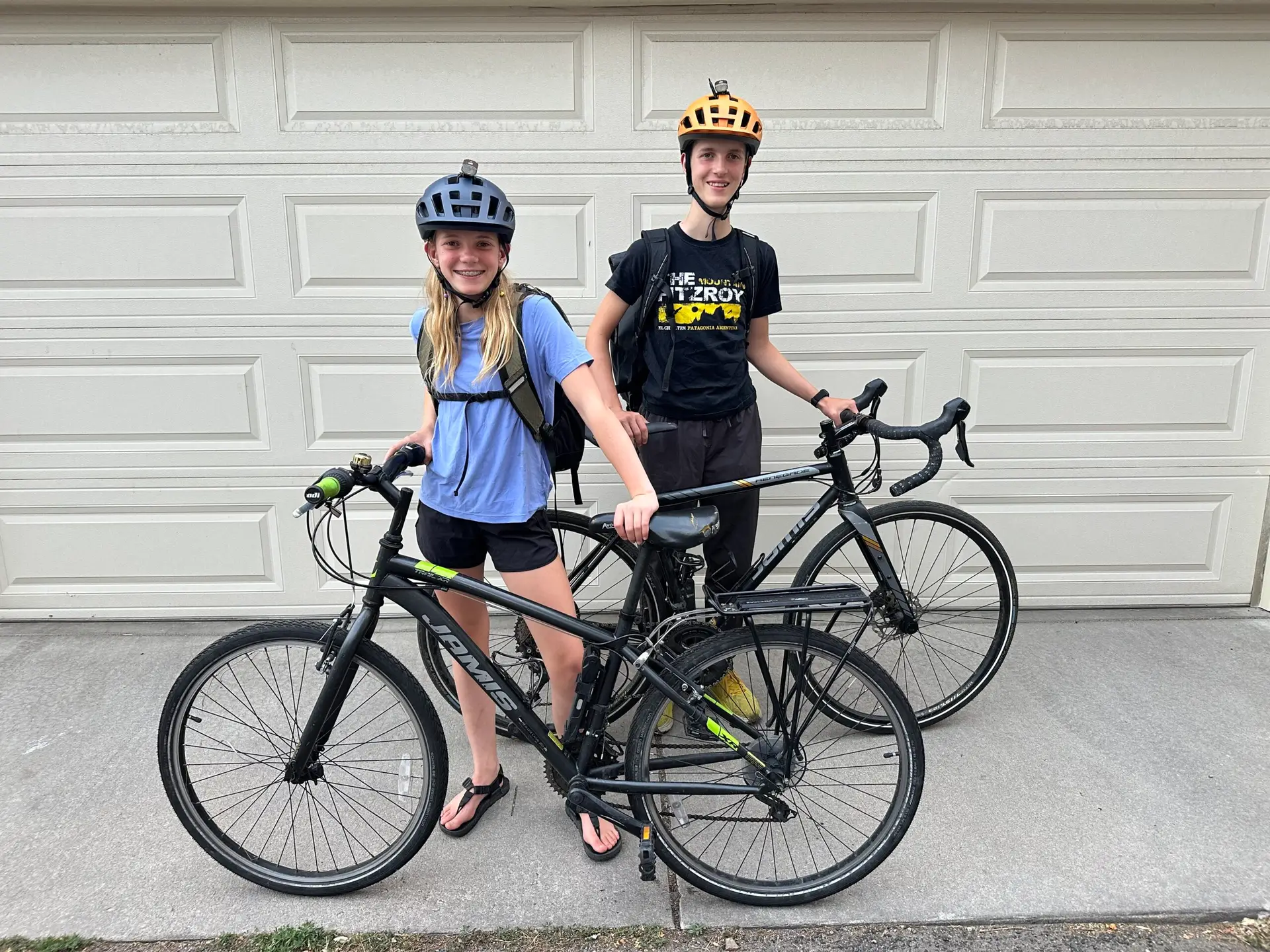 Siblings stand with their bikes