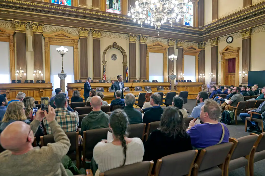Man speaking to group inside the capitol