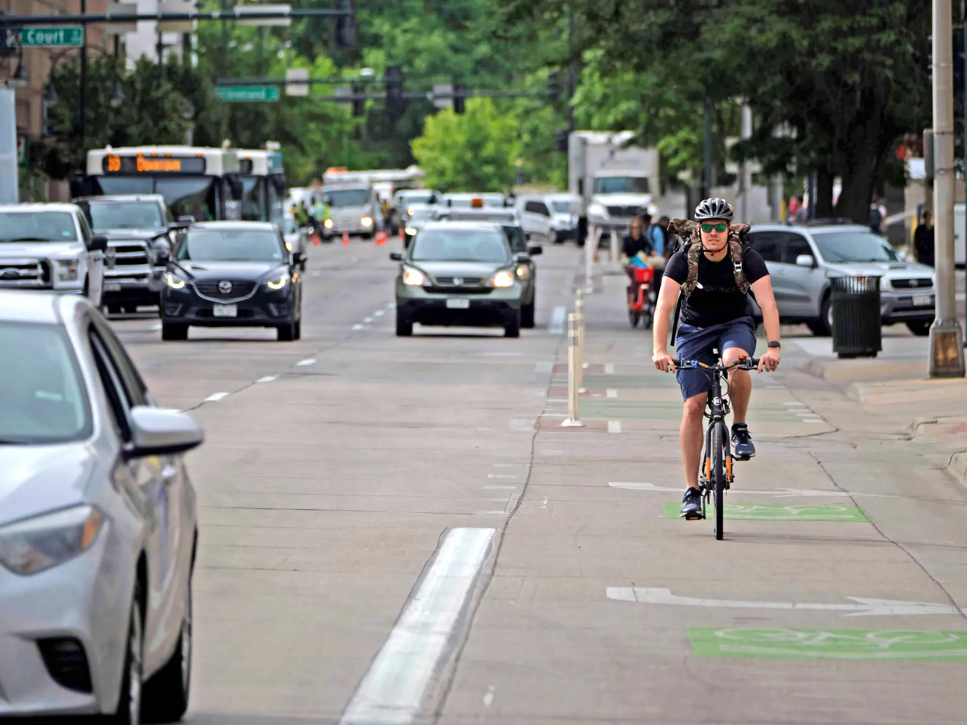 Bicyclist rides in a bike lane on a road