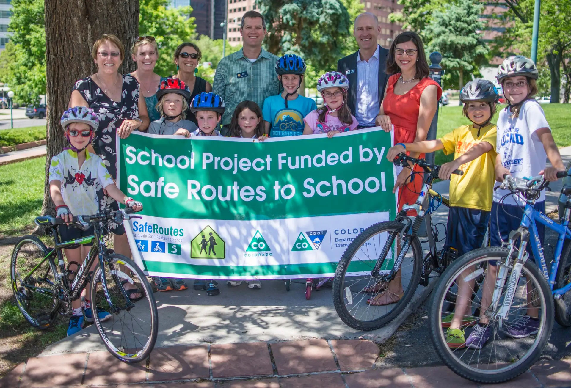 Group of kids and adults with banner