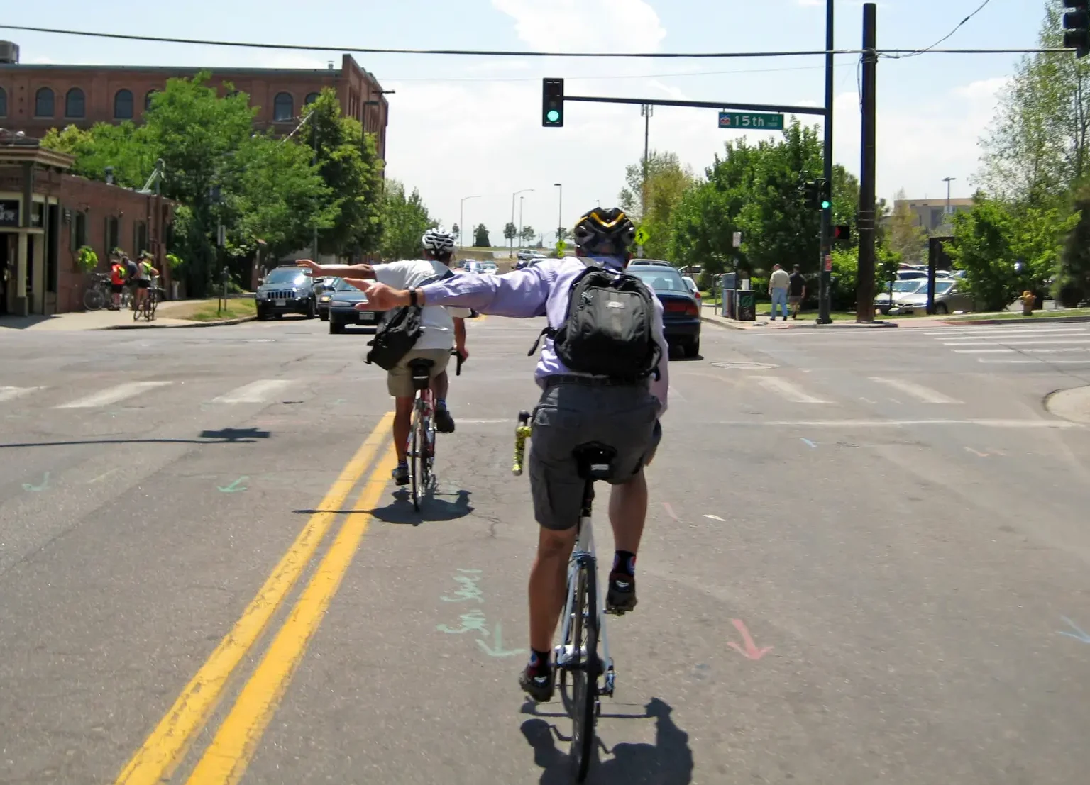 Bicyclists signaling with their hands