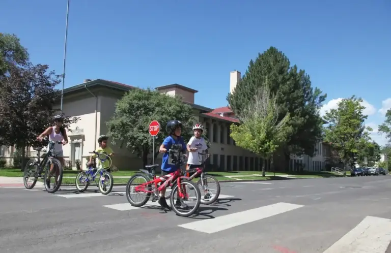 Family of bicyclists walks their bikes