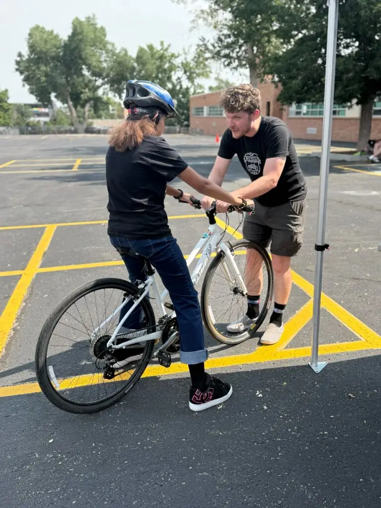Instructor teaching a child to ride a bike