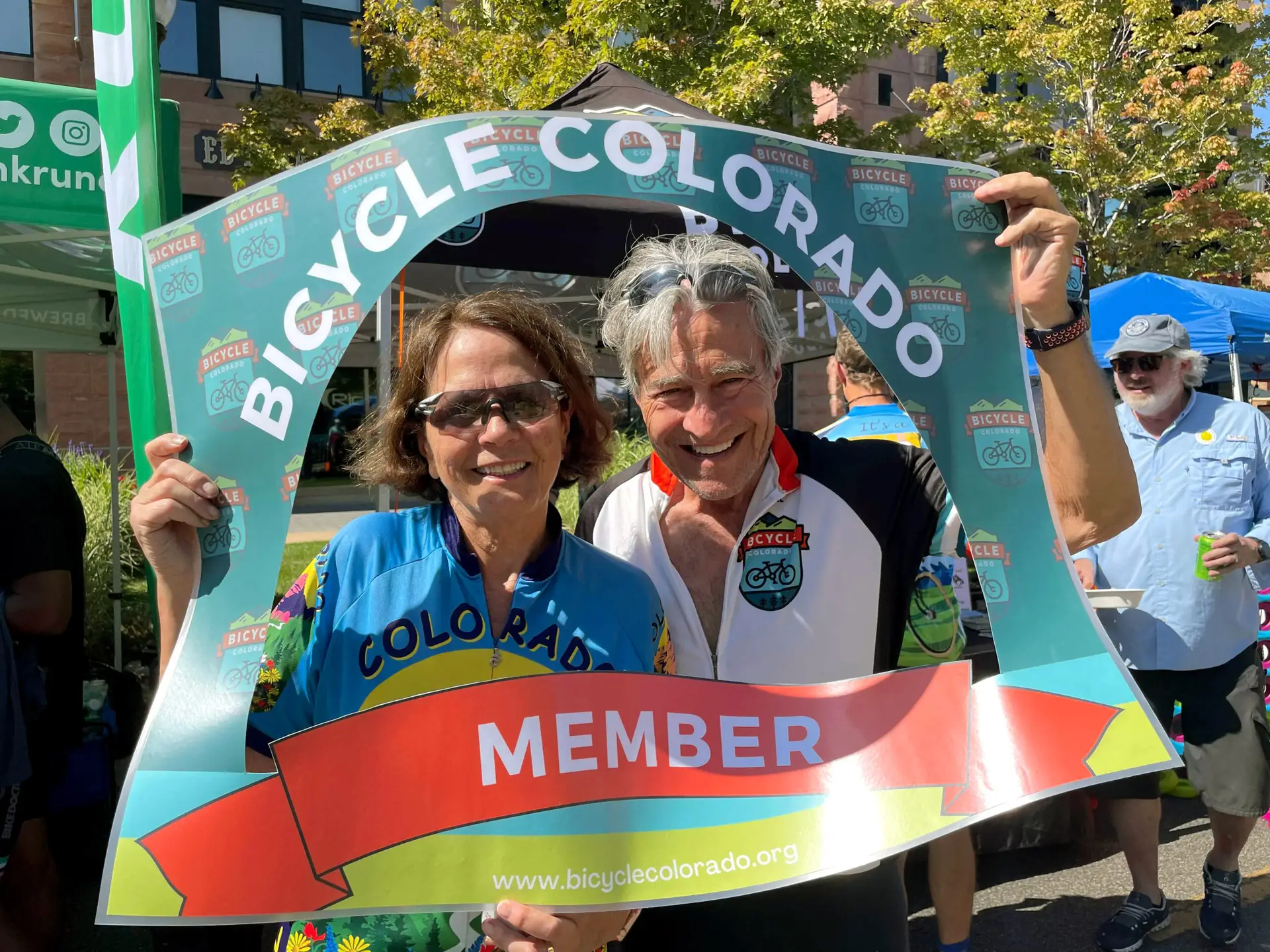 Two adults with a sign
