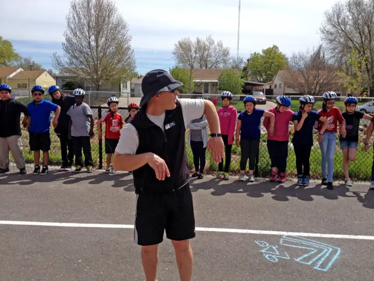 Adult instructor teaches bike signaling