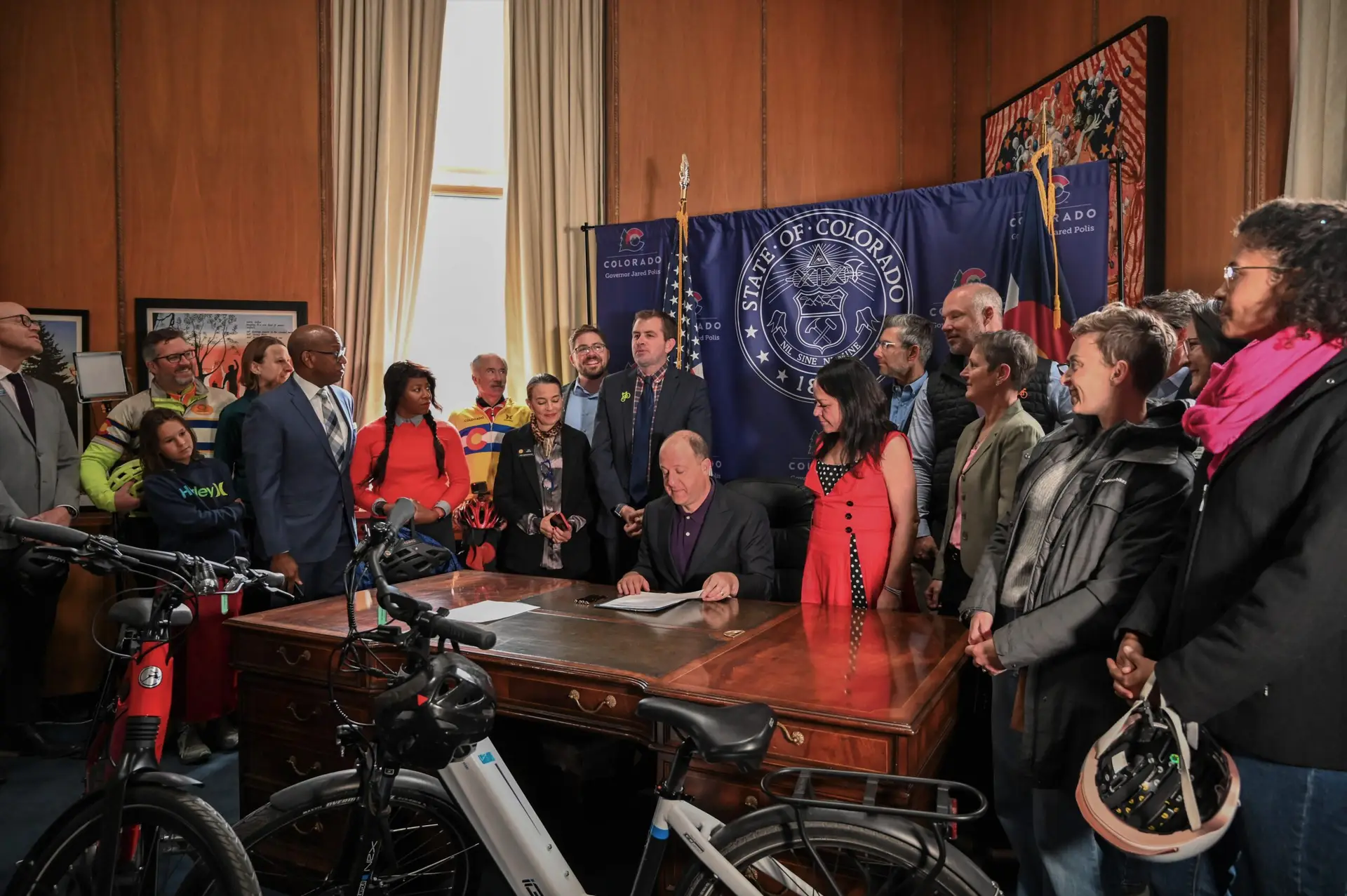 Group of people with the Governor signing a bill.