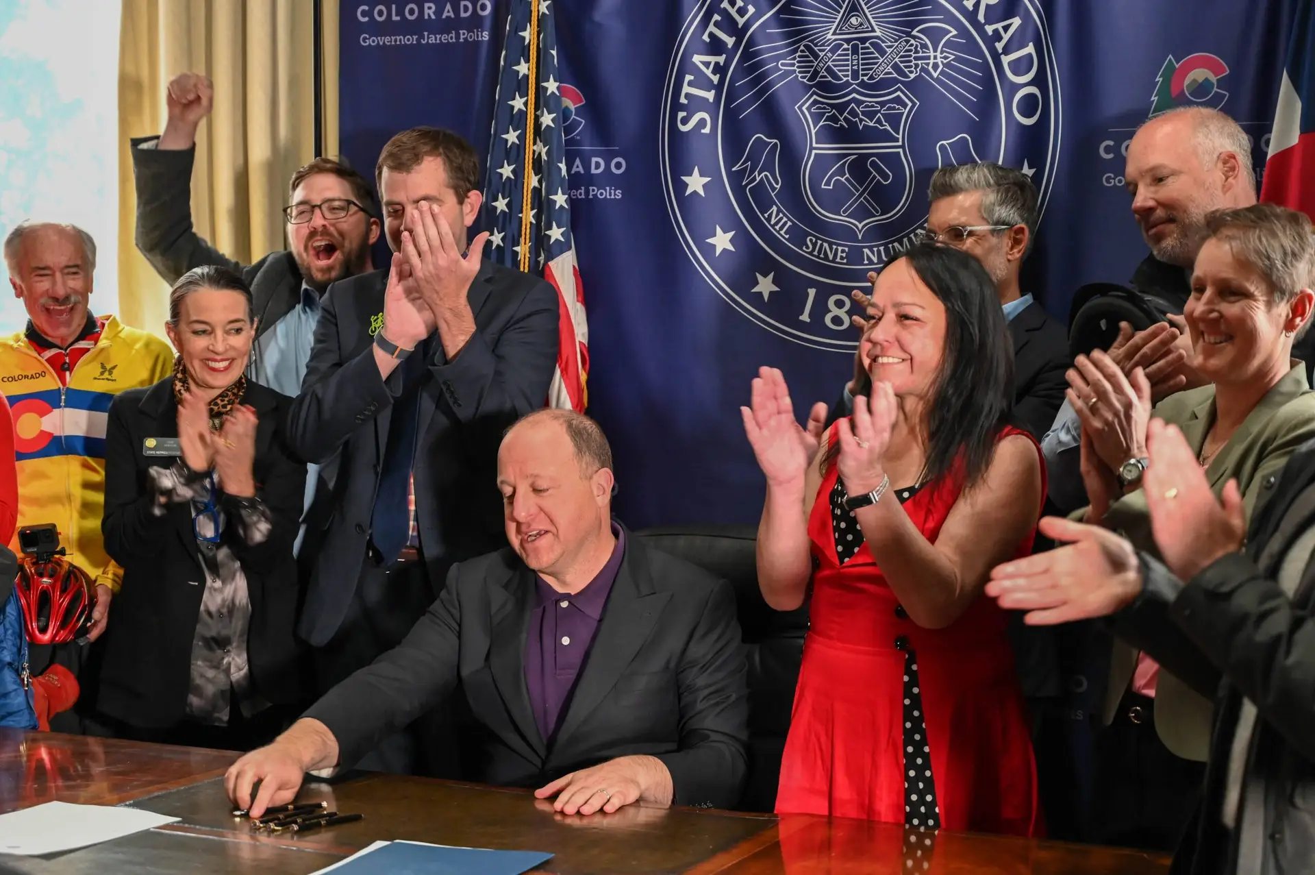 Group celebrates the signing of a bill