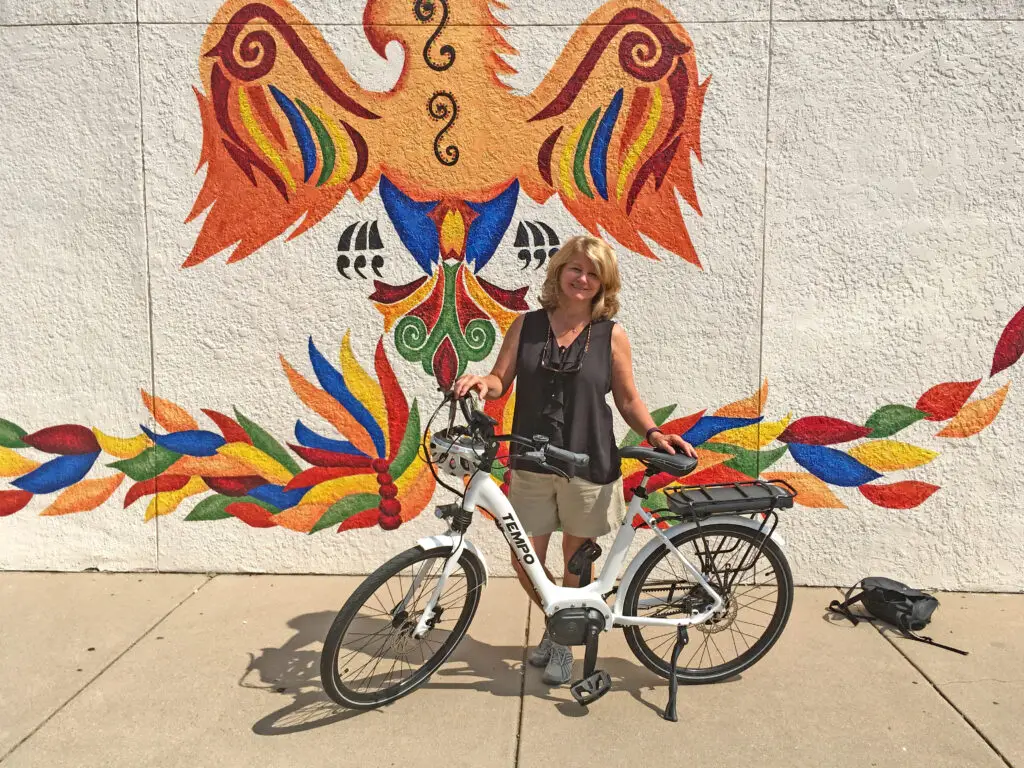 Woman standing with a bike