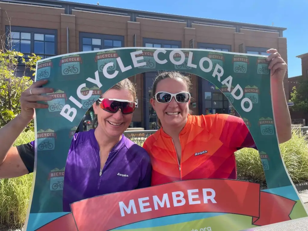 Two Bicycle Colorado members with signs