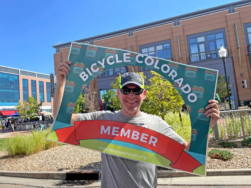 Man with Bicycle Colorado member sign