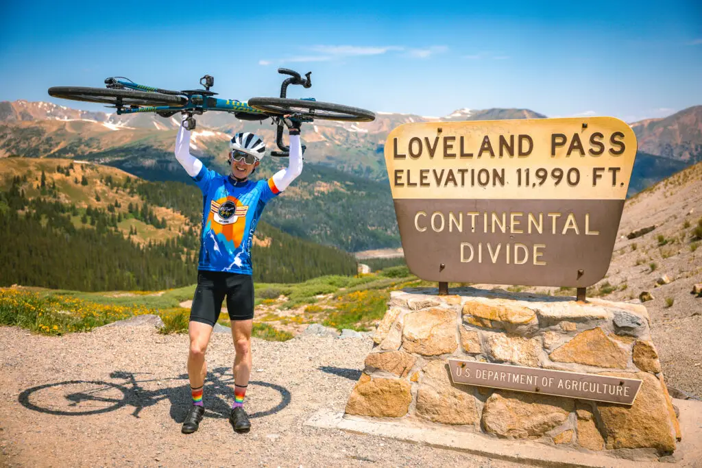Man holding bike at mountain pass