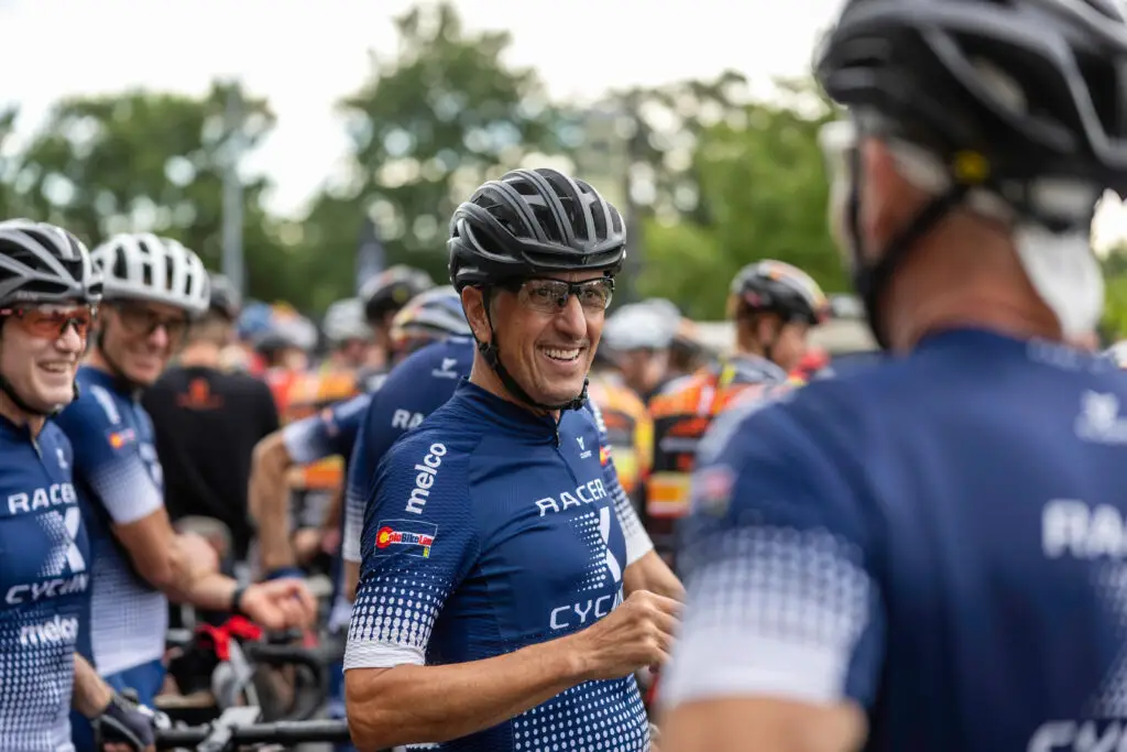 A bicyclist gathers with other riders