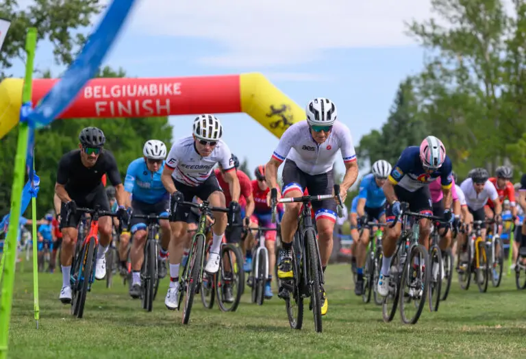 Bicyclists ride on the grass in a race