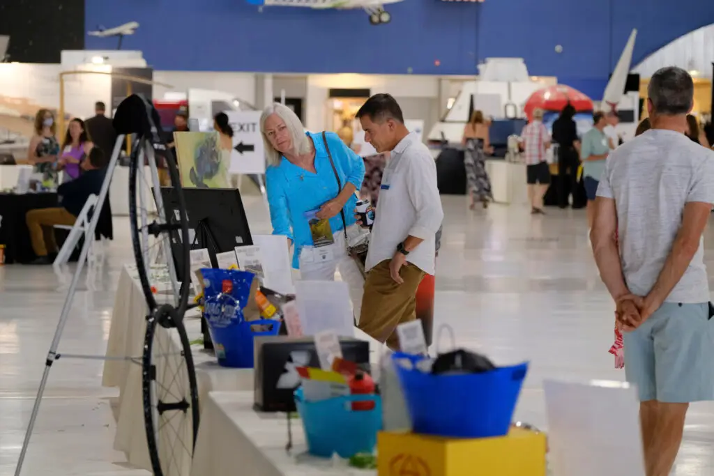 Guests look at silent auction items
