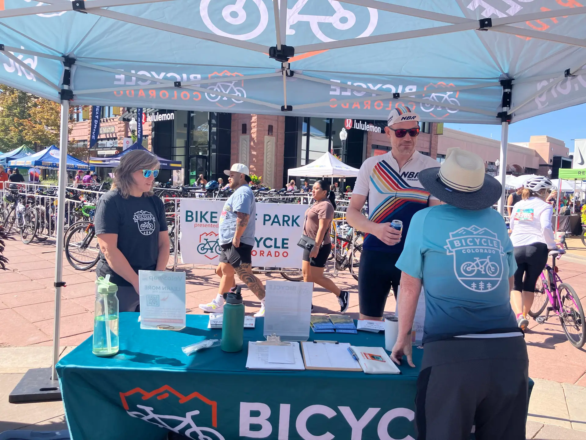 Bicycle Colorado volunteers talk to bicyclist