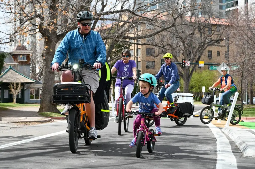 Bicyclists ride on a new bikeway path in Denver