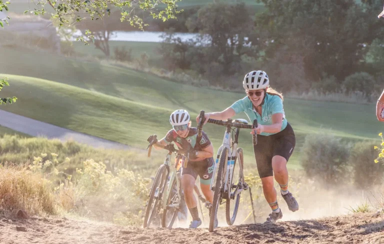 Bicyclists push their bikes uphill