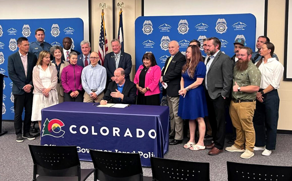Advocates and legislators at bill signing